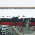 typewriter with the phrase 'to blog... or not to blog'