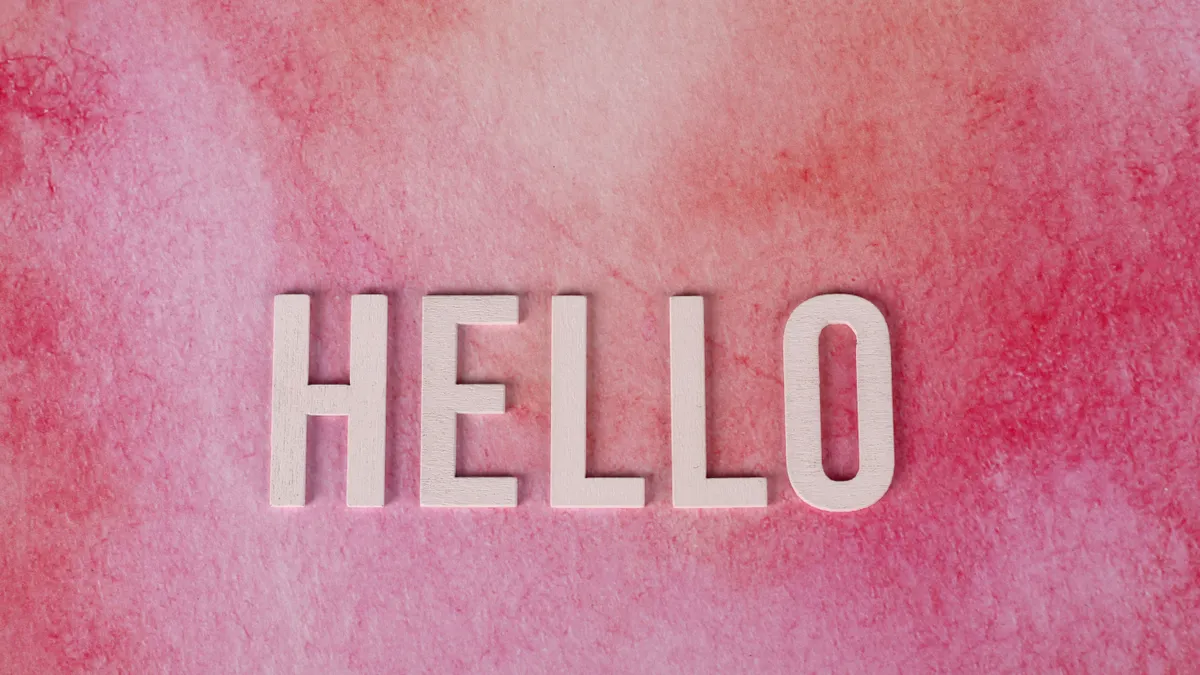 pink background with the word HELLO in large letters
