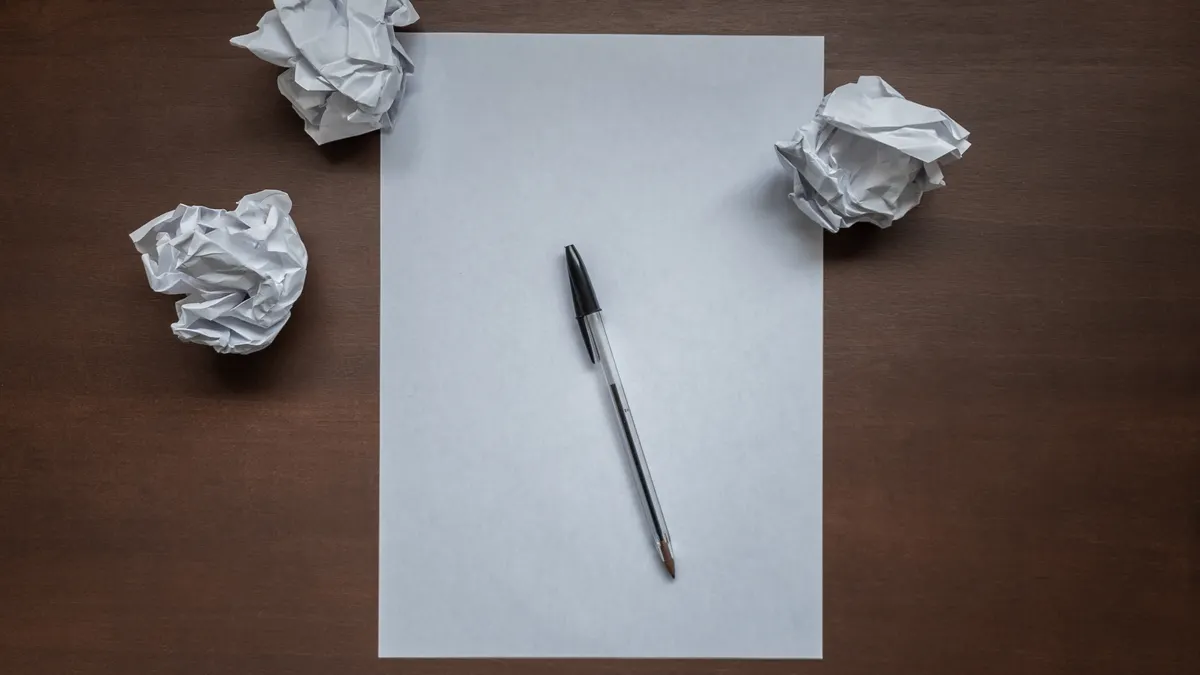 AI writer workflow for bloggers: from idea to published post in five steps — Flat lay with blank writing sheet, pen and 