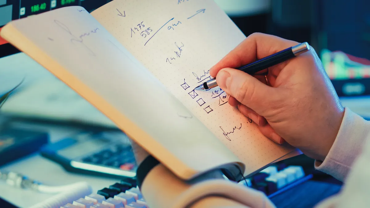 AI Writing Workflows & Optimization for Bloggers — The Complete Guide — Person Writing in Notebook for Stock Market Plan